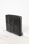 Black leather wallet with zipper on a white background