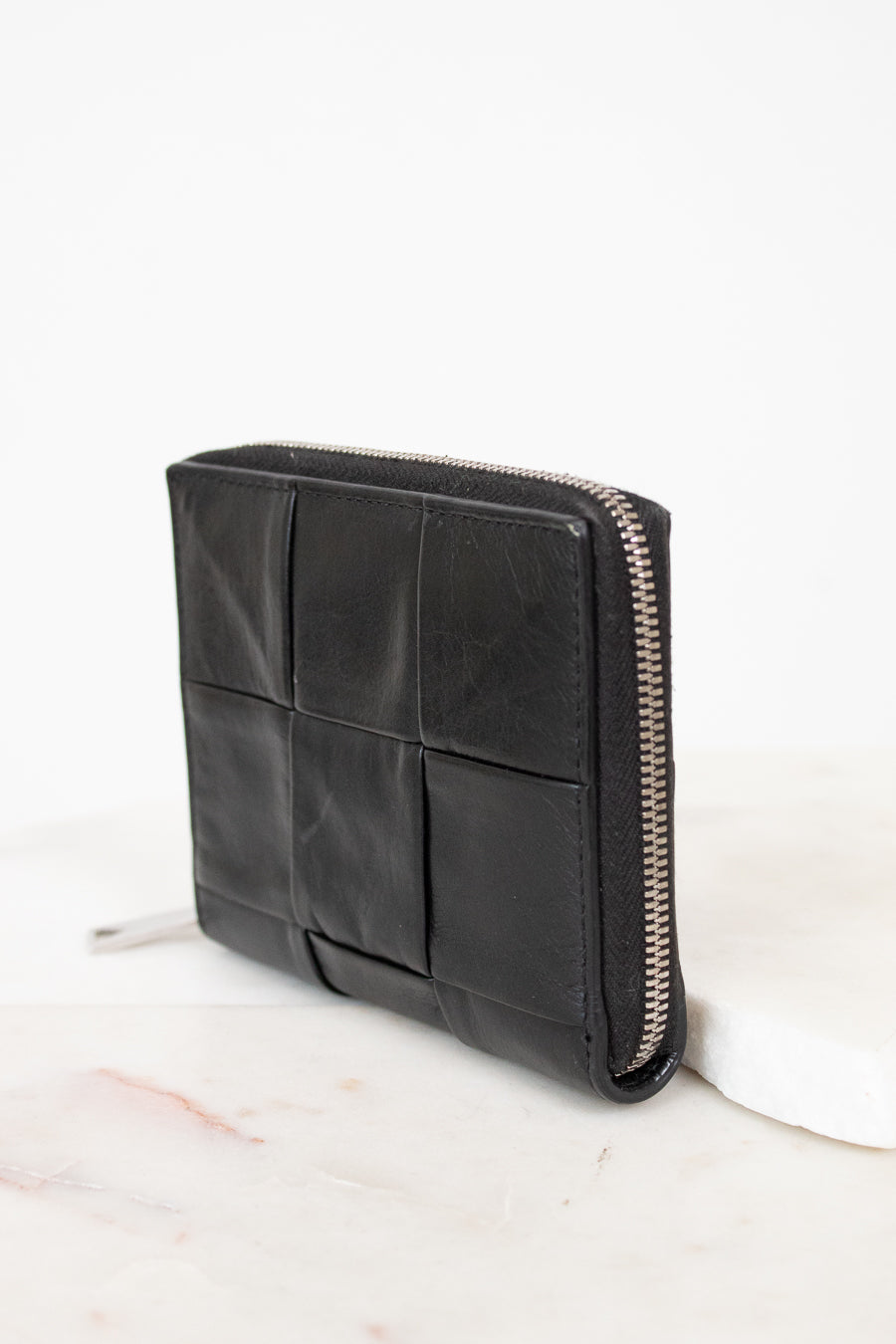 Black leather wallet with zipper on a white background