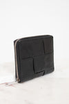 Black leather clutch bag with geometric design on a white background