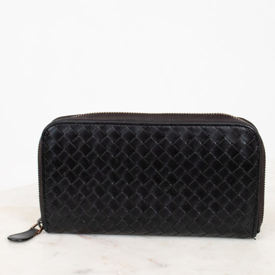 Black woven wallet on a white background