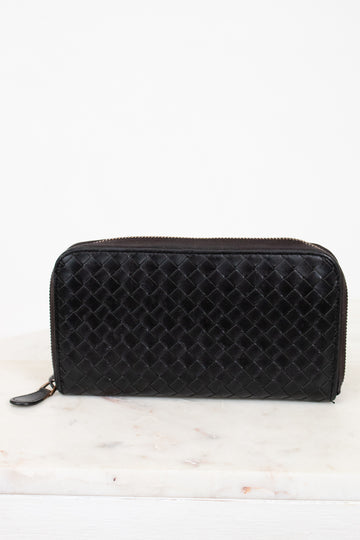 Black woven wallet on a white background