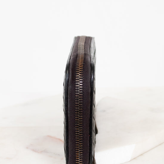 Black leather wallet with zipper on a white background