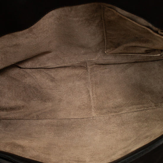 Close-up of a brown leather bag interior with visible stitching