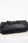 Black woven clutch on a white background