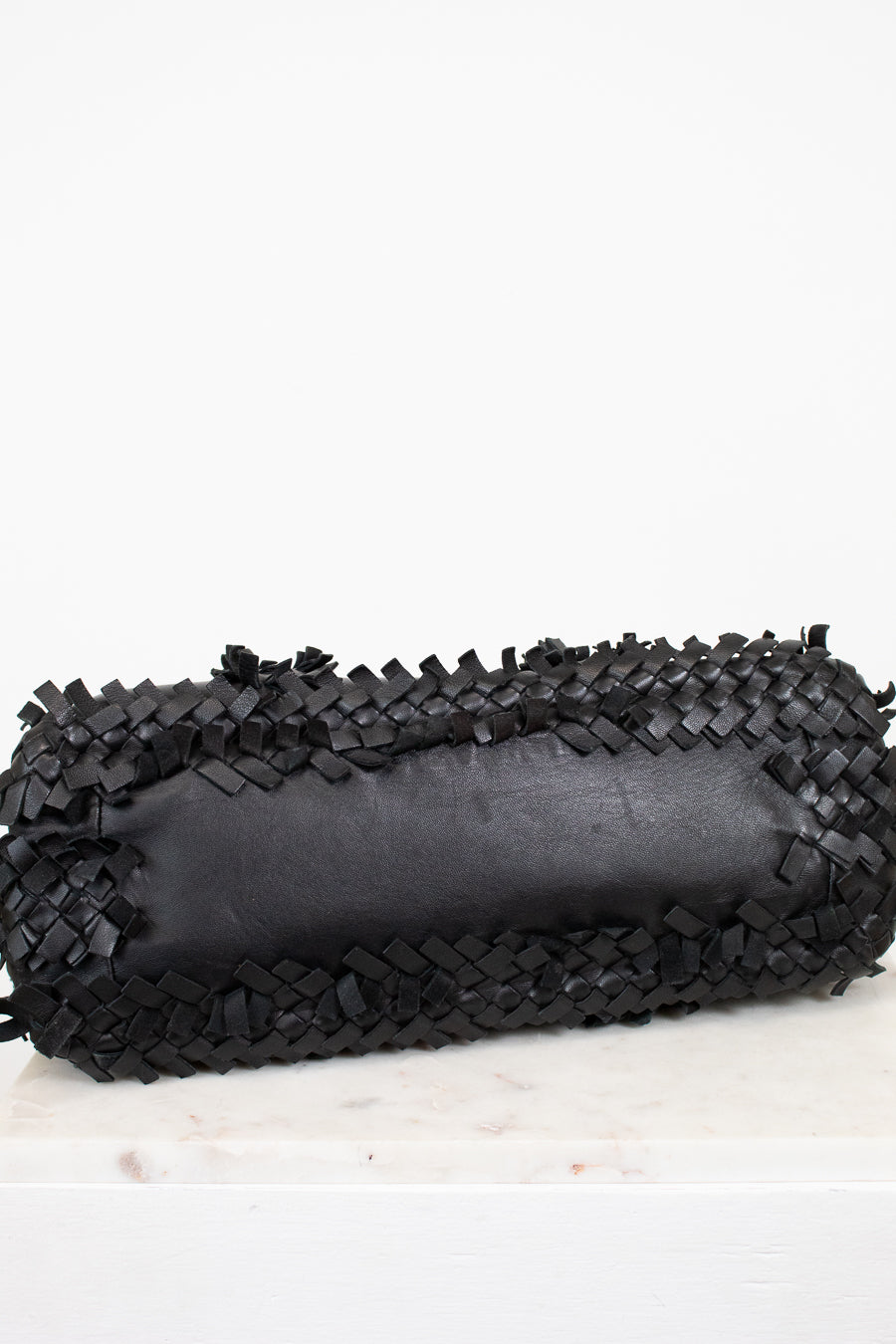 Black woven clutch on a white background