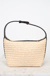 Woven handbag with black leather trim on a white background