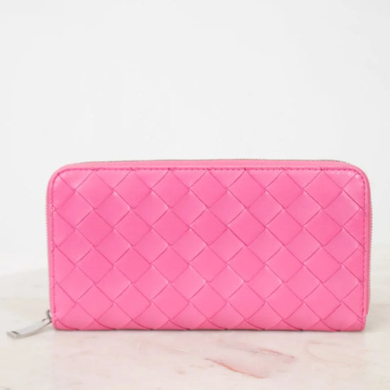 Pink quilted wallet on a white background