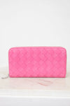 Pink quilted wallet on a white background
