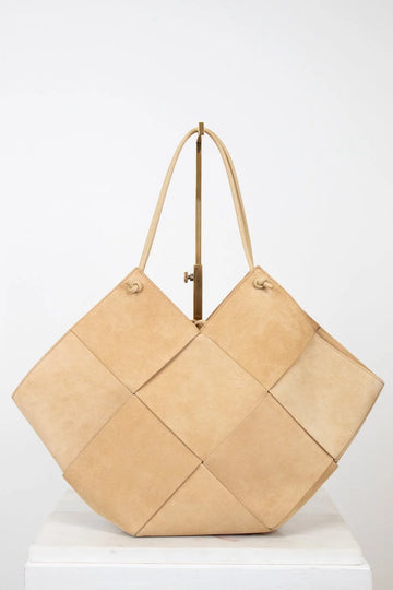 Beige woven handbag on a white background