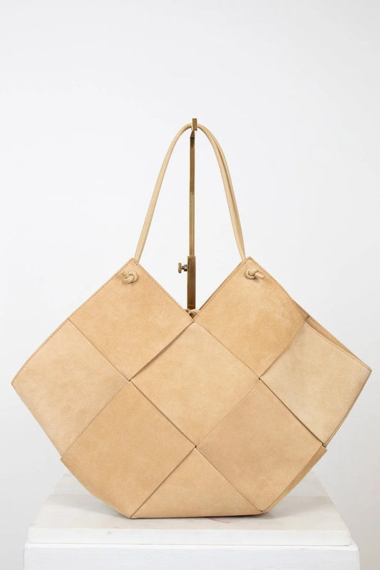 Beige woven handbag on a white background