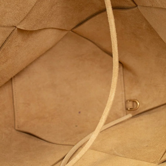Close-up of a brown leather bag with a strap