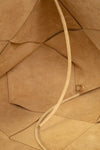Close-up of a brown leather bag with a strap