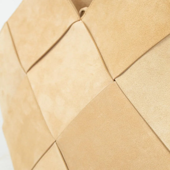 Beige woven handbag on a light background