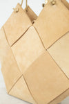 Beige woven handbag on a light background