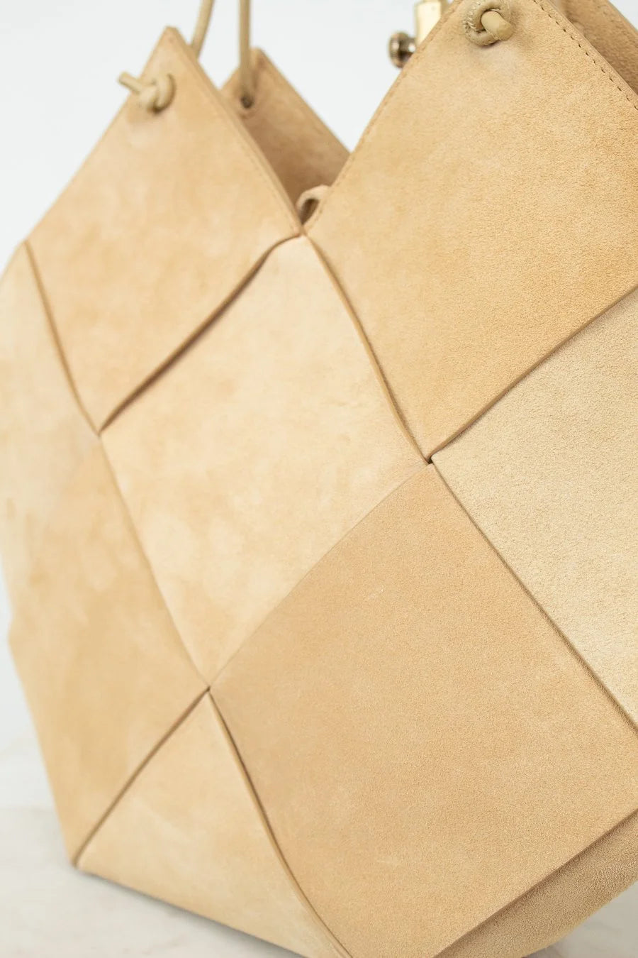 Beige woven handbag on a light background