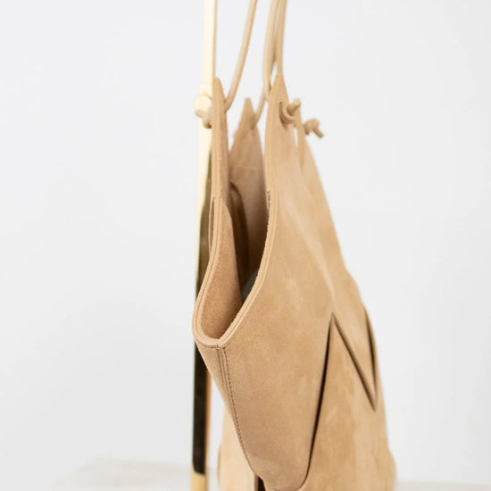 Beige handbag with a strap on a white background