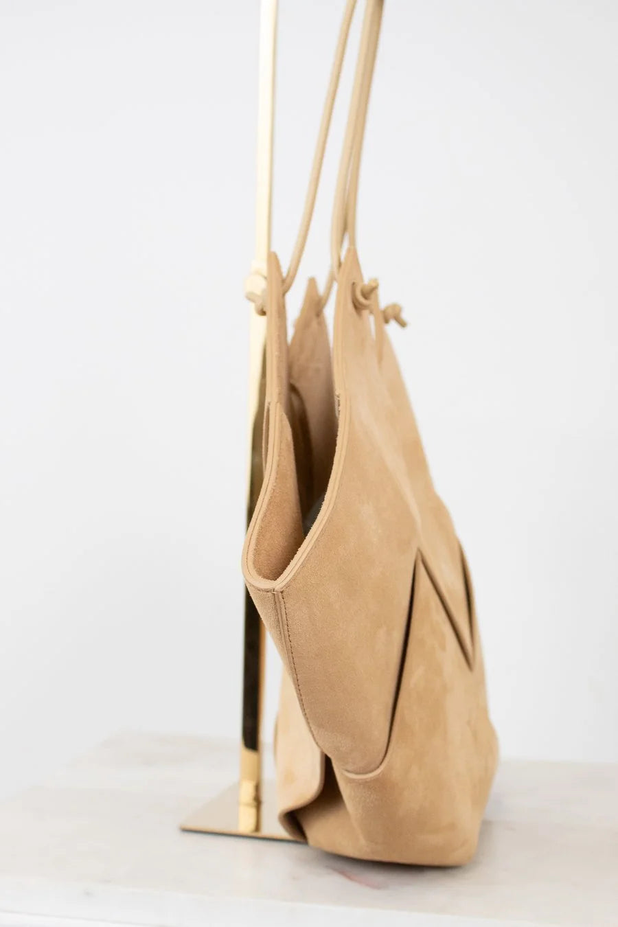 Beige handbag with a strap on a white background
