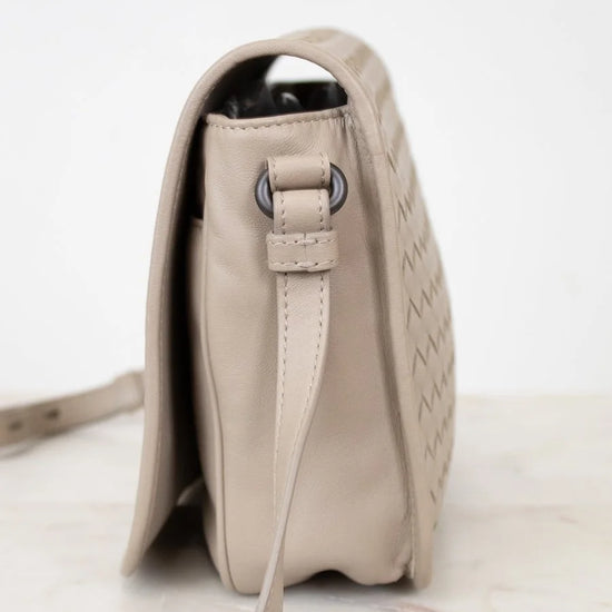 Beige handbag with a strap on a light background