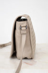 Beige handbag with a strap on a light background