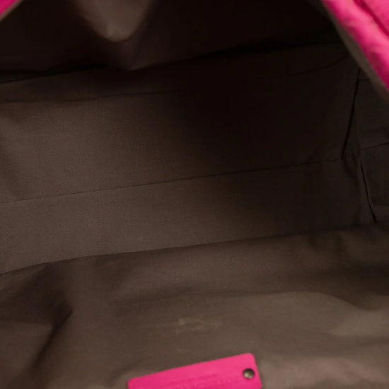 Close-up of a pink and black bag with a visible brand logo.