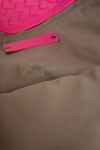 Brown fabric lining with a pink label and pink logo in the corner