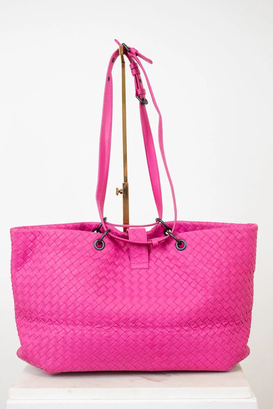 Pink woven tote bag on a white background