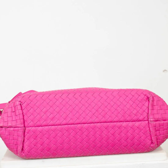 Pink quilted bag on a white background