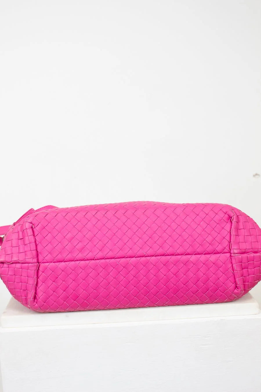 Pink quilted bag on a white background
