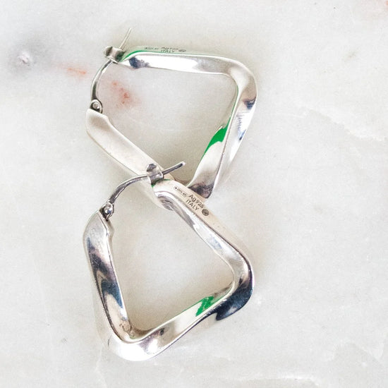 Silver hoop earrings on a light background