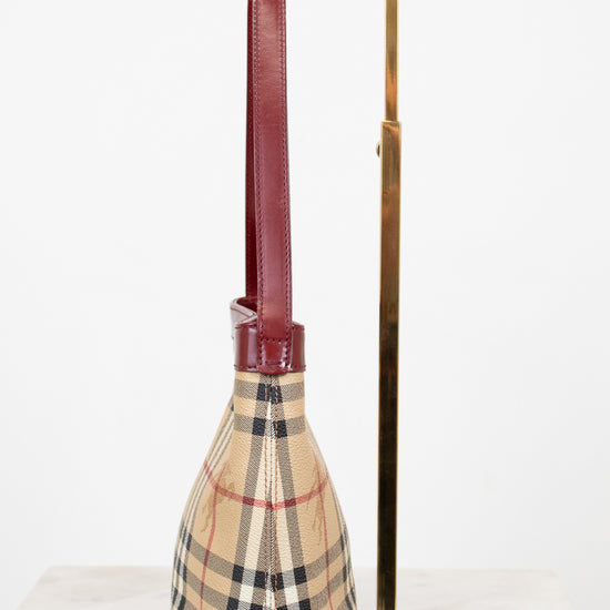 Checkered bag with a long handle on a white background