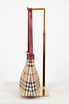 Checkered bag with a long handle on a white background