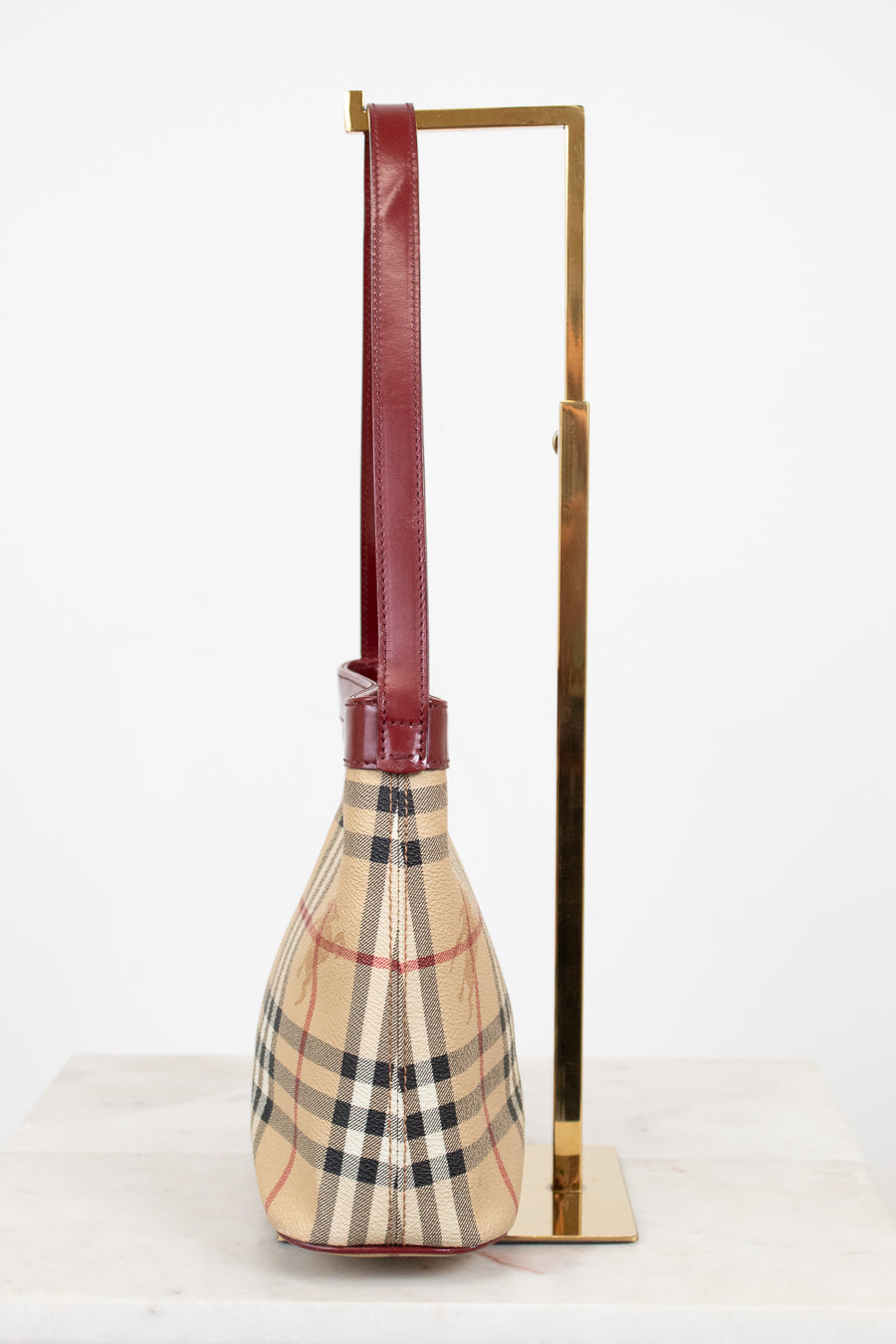 Checkered bag with a long handle on a white background