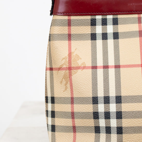Plaid patterned handbag with a visible brand logo on a white background