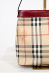 Plaid patterned handbag with a visible brand logo on a white background