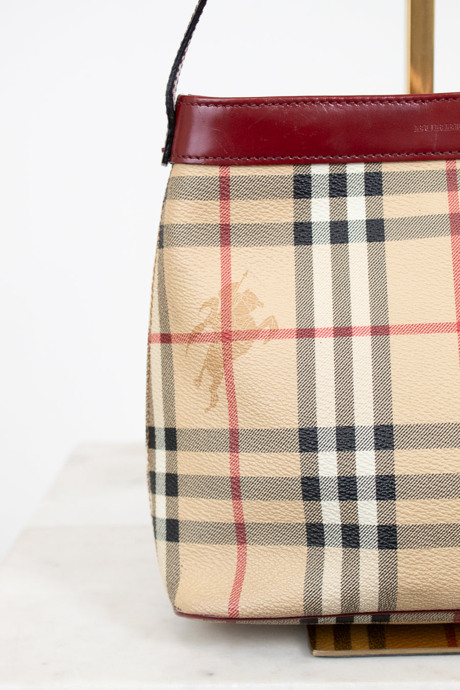 Plaid patterned handbag with a visible brand logo on a white background