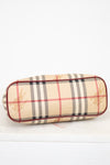 Bottom view of check patterned Burberry bag on white background