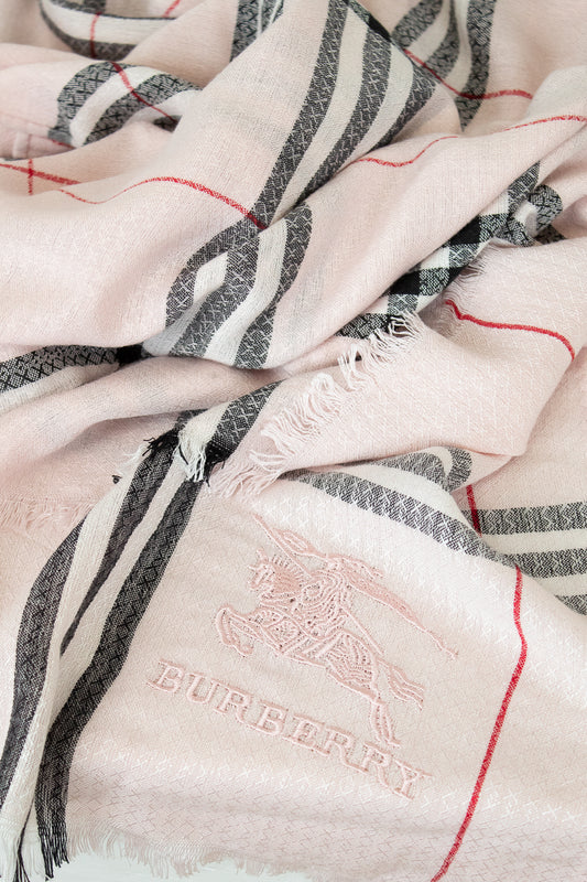 Close-up of a Burberry scarf with checkered pattern and brand logo.