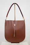 Brown handbag with a braided handle on a white background
