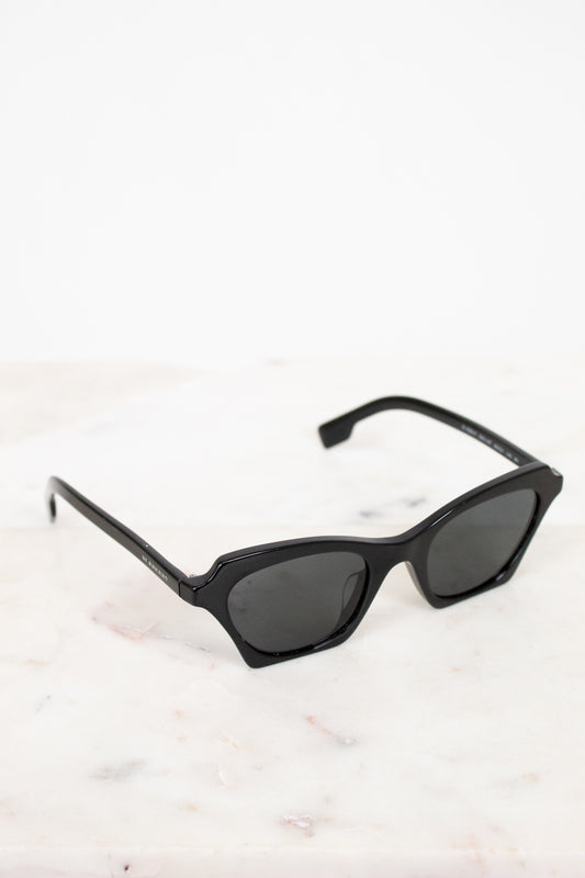 Black sunglasses on a light marble surface