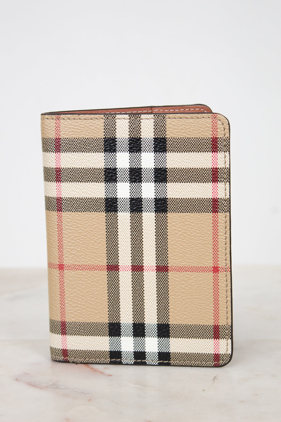 Plaid patterned wallet on a light background