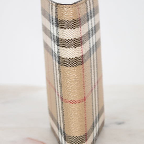 Plaid patterned passport holder on a marble surface