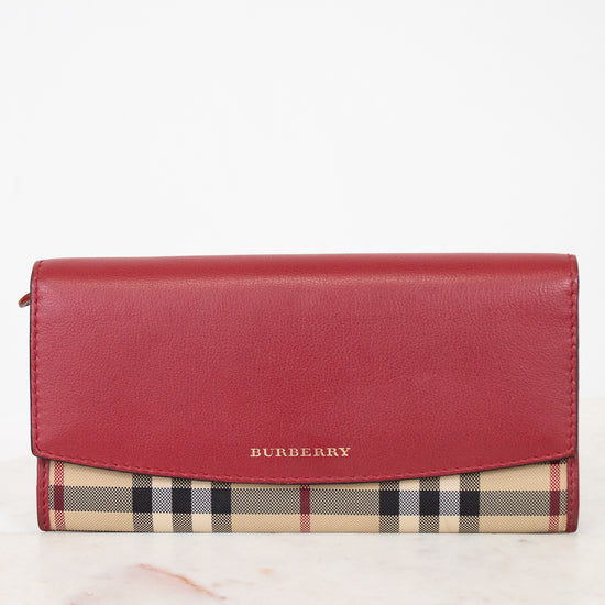 Red Burberry wallet with checkered pattern on a white background