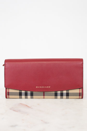 Red Burberry wallet with checkered pattern on a white background