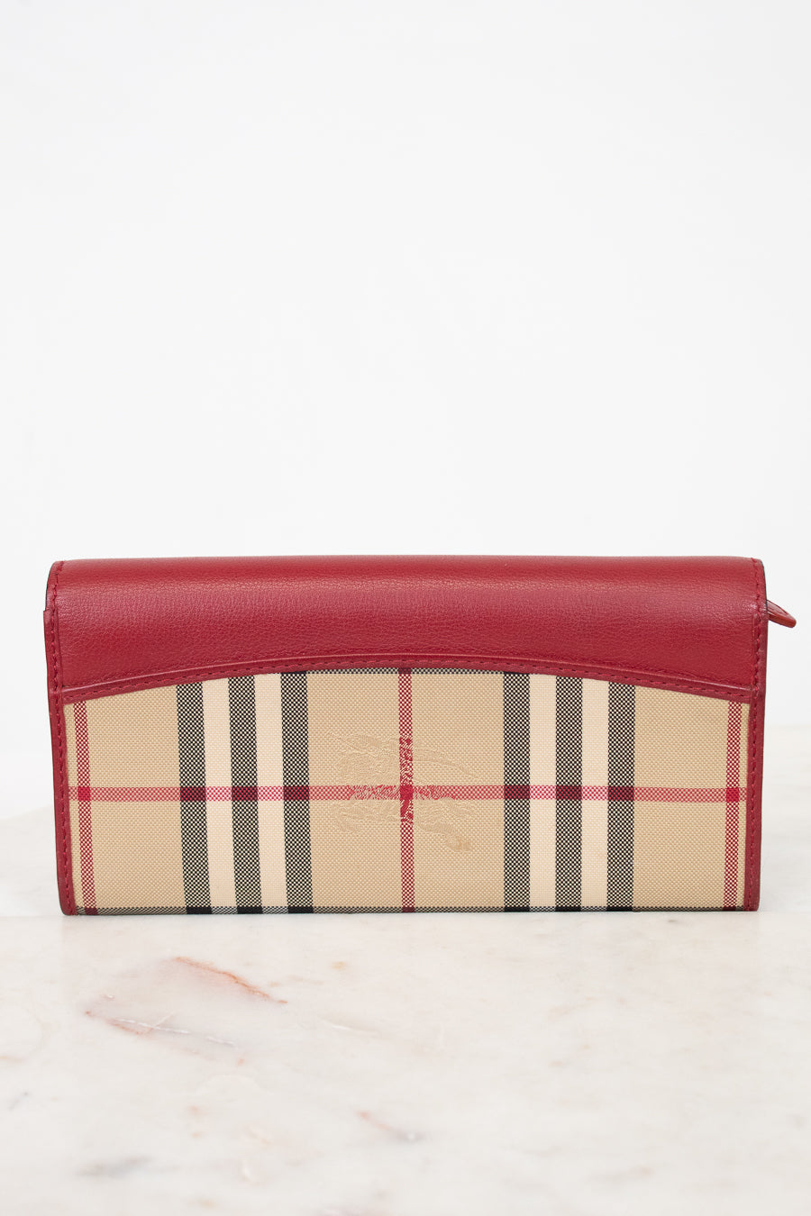 Red and beige checkered wallet on a white background
