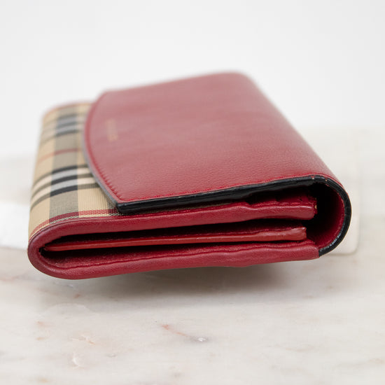 Red wallet with checkered pattern on a marble surface
