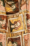 Close-up of neutral toned framed portraits printed on a light material scarf