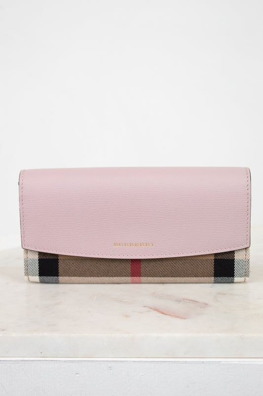 Pink wallet with checkered pattern on a white surface