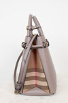 A structured leather handbag in taupe with gold-tone hardware and a signature beige, brown, and red check pattern panel on the front, shown against a clean white background.
