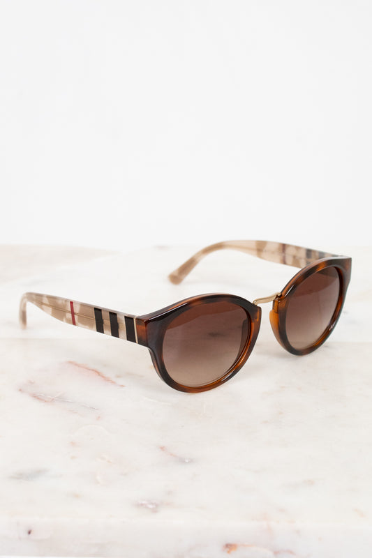 Sunglasses with checkered frame on a marble surface