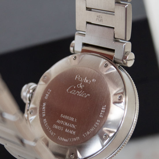 Close-up of a Cartier watch back cover with metal band
